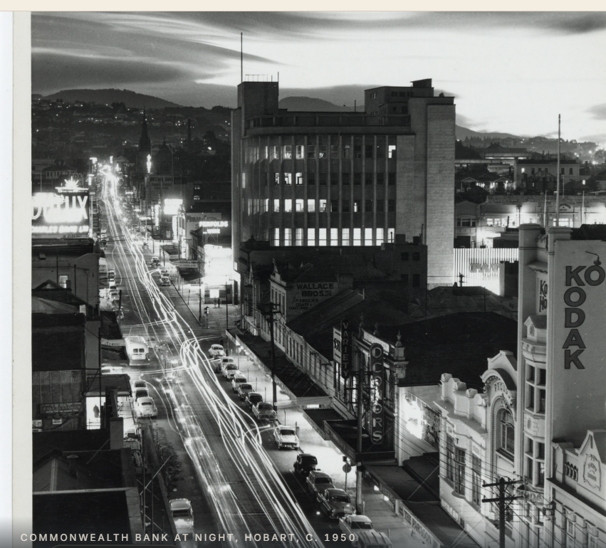 Black and white night photograph of the Commonwealth Bank building on a Hobart street with dramatic sky, circa 1950